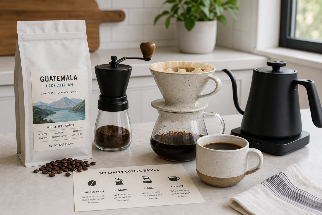 Whole bean coffee, hand grinder, ceramic pour over dripper, kettle, and brewed cup on a kitchen counter.