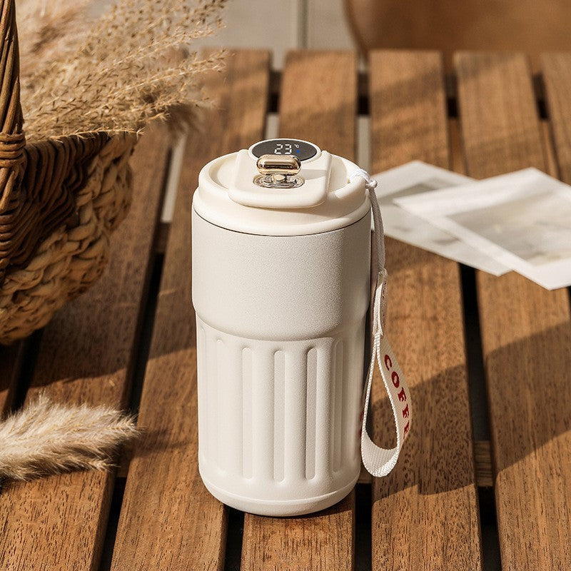 White smart digital thermal bottle with white lid and temperature display, 450ml. A sleek, insulated coffee mug for maintaining drink temperature.