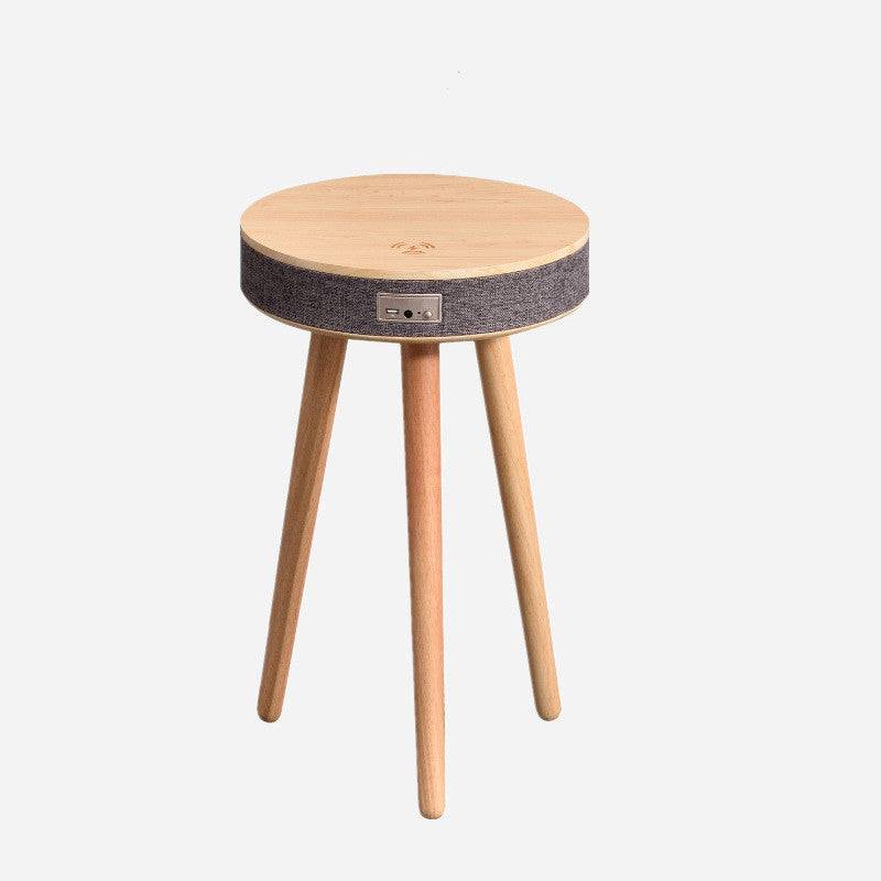 Modern Bluetooth speaker coffee table with wireless charging, featuring a round wooden top and fabric-wrapped speaker design. Ideal for smart home decor.