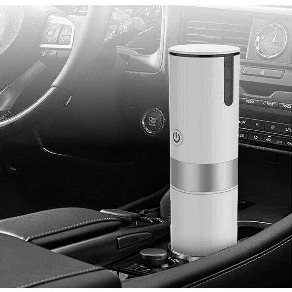 White portable espresso machine placed in a car cup holder. Ideal for brewing fresh espresso on the go with ground coffee or capsules.