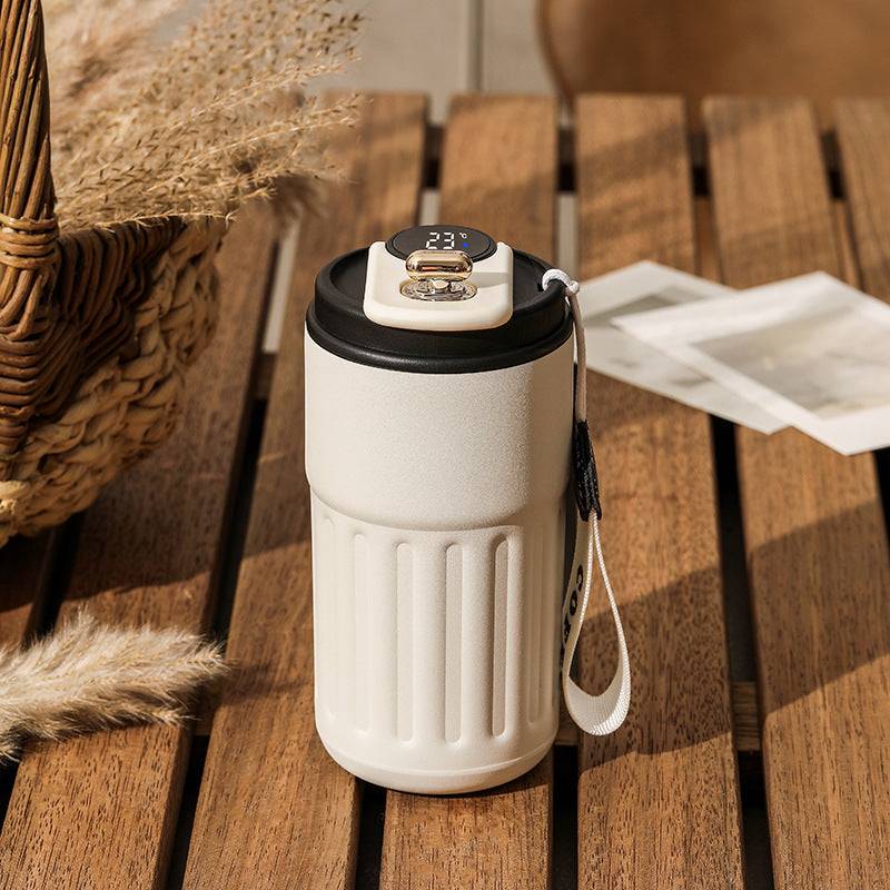 White smart digital thermal bottle with black lid and temperature display, 450ml. Perfect for keeping beverages at the ideal temperature throughout the day.