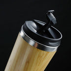 Bamboo coffee cup with 14oz capacity, featuring double-wall insulation and a non-slip grip. Eco-friendly, reusable, and ideal for sustainable living.