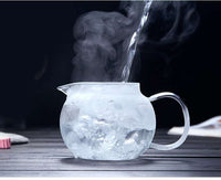 Pouring hot water into the Flower Glass Teapot