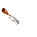 Teak lacquer rice paddle with ergonomic handle scooping white rice with black sesame seeds. Durable, eco-friendly Japanese-style kitchen utensil.