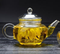 Large capacity glass teapot filled with brewed tea"