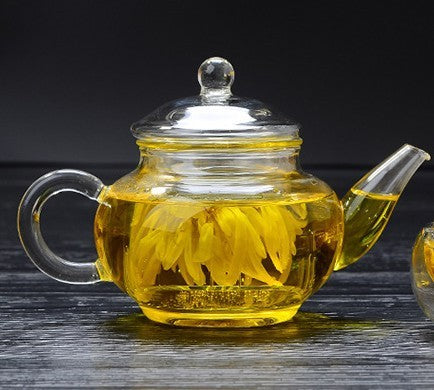 Large capacity glass teapot filled with brewed tea"