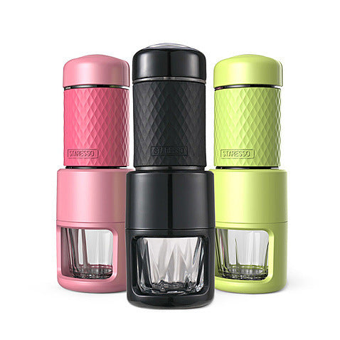 a group of four different colored coffee makers