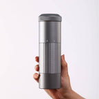 Portable Wireless Bean Grinder held in hand, showcasing its sleek and compact design. USB rechargeable for convenient coffee grinding.
