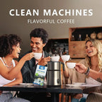 People enjoying coffee together with a coffee machine and package in the foreground.