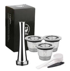Reusable coffee pods set with stainless steel refillable capsule, tamper, cleaning brush, and scoop. Compatible with Nespresso machines for sustainable brewing.
