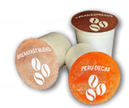 Three coffee capsules with labels for 'Breakfast Blend', 'Peru Decaf', and a branded container on a white background.