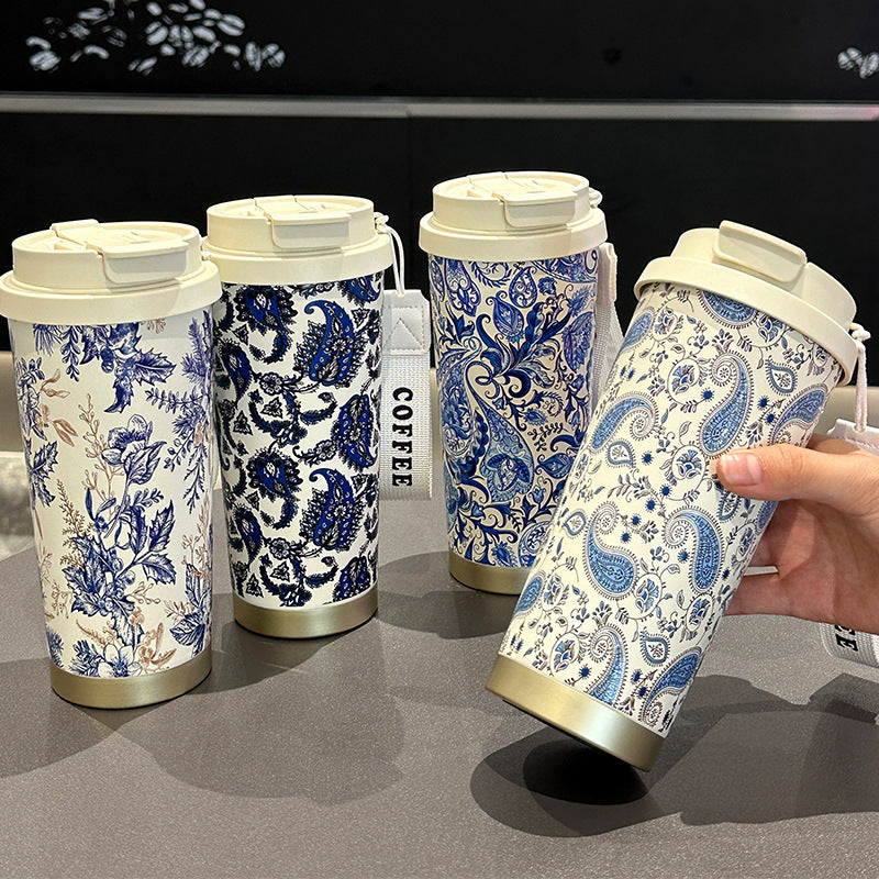 Blue and white porcelain travel coffee cup with stainless steel interior and double-wall insulated portable design