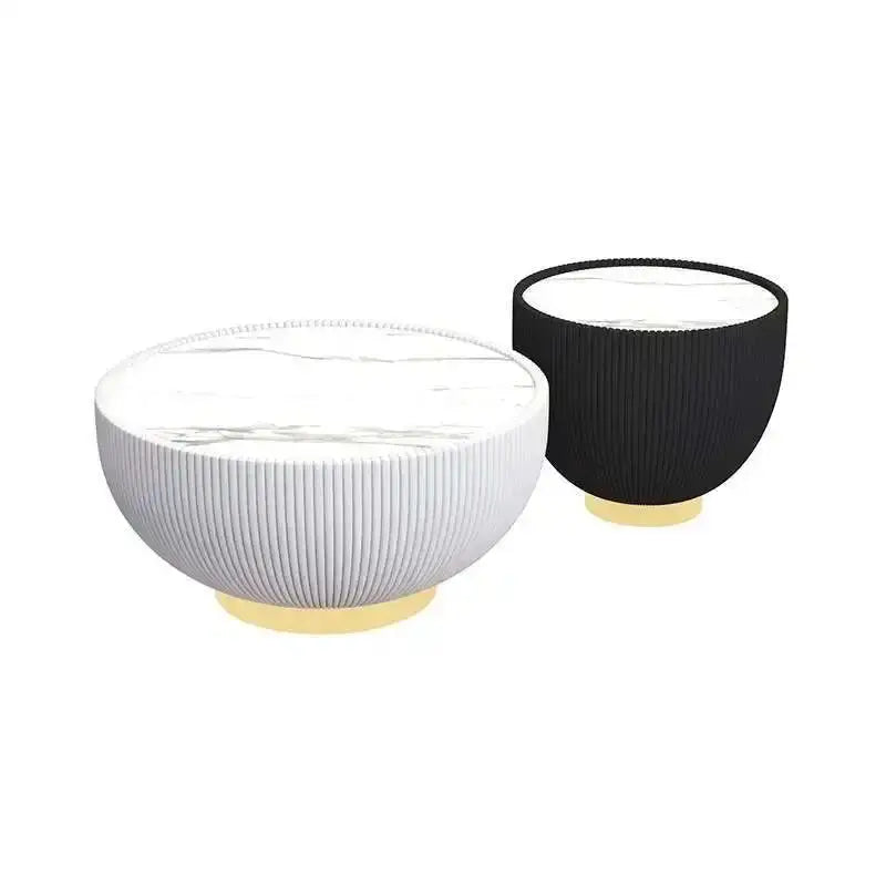 Two ceramic bowls, one white and one black, on a white background