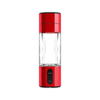 Red portable juice blender with a clear container on a white background
