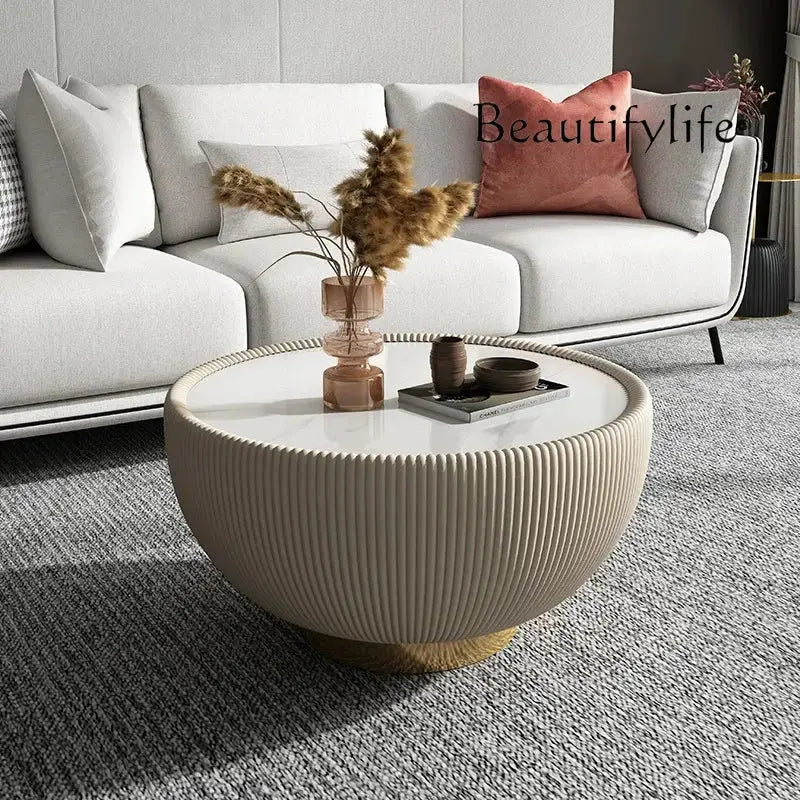 Living room with a white sofa, round coffee table, and decorative items.