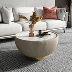 Living room with a white sofa, round coffee table, and decorative items.