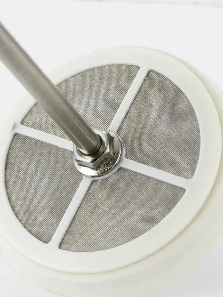 Close-up of a metal filter with a white background