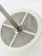 Close-up of a metal filter with a white background