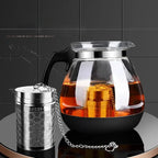 Loose tea strainer with chain hook hanging in cup