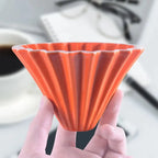 Elegant ceramic coffee dripper on a wooden countertop"