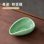 Ceramic coffee beans dosing cup with a speckled glaze finish, featuring a tapered spout for precise pouring. Ideal for measuring espresso beans with accuracy.