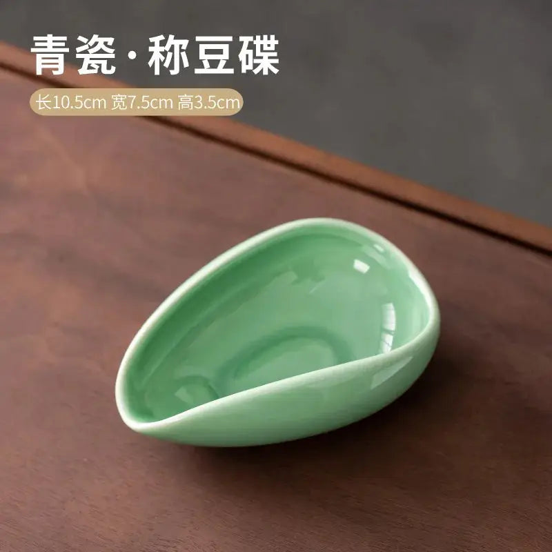 Ceramic coffee beans dosing cup with a speckled glaze finish, featuring a tapered spout for precise pouring. Ideal for measuring espresso beans with accuracy.