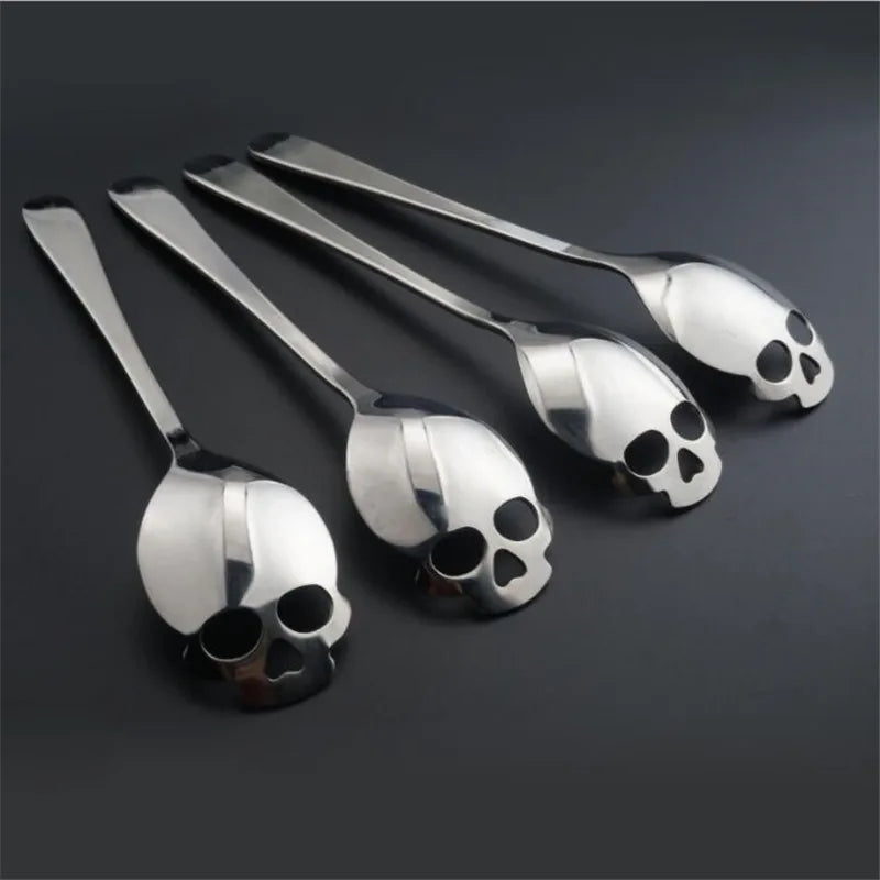 Set of four stainless steel skull-shaped coffee spoons with a polished finish, perfect for coffee, tea, and desserts. Stylish gothic kitchen accessory.