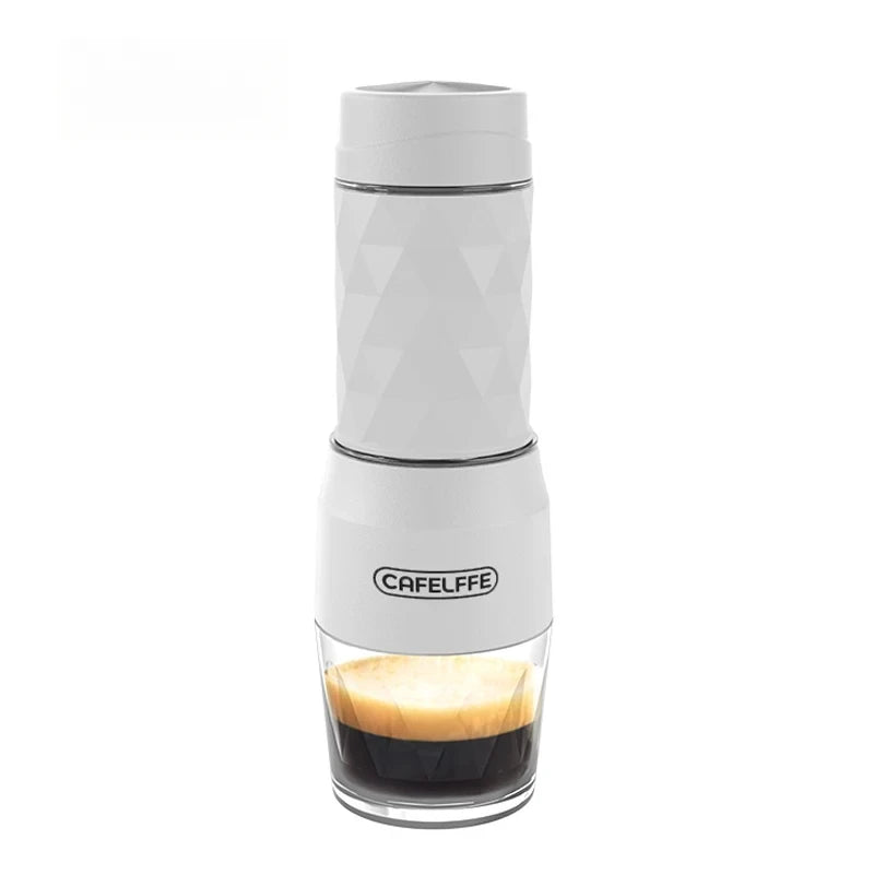 Compact white manual espresso maker with geometric pattern, featuring a clear base showing brewed espresso.