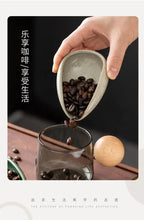 Ceramic coffee beans dosing cup with a speckled glaze finish, featuring a tapered spout for precise pouring. Ideal for measuring espresso beans with accuracy.