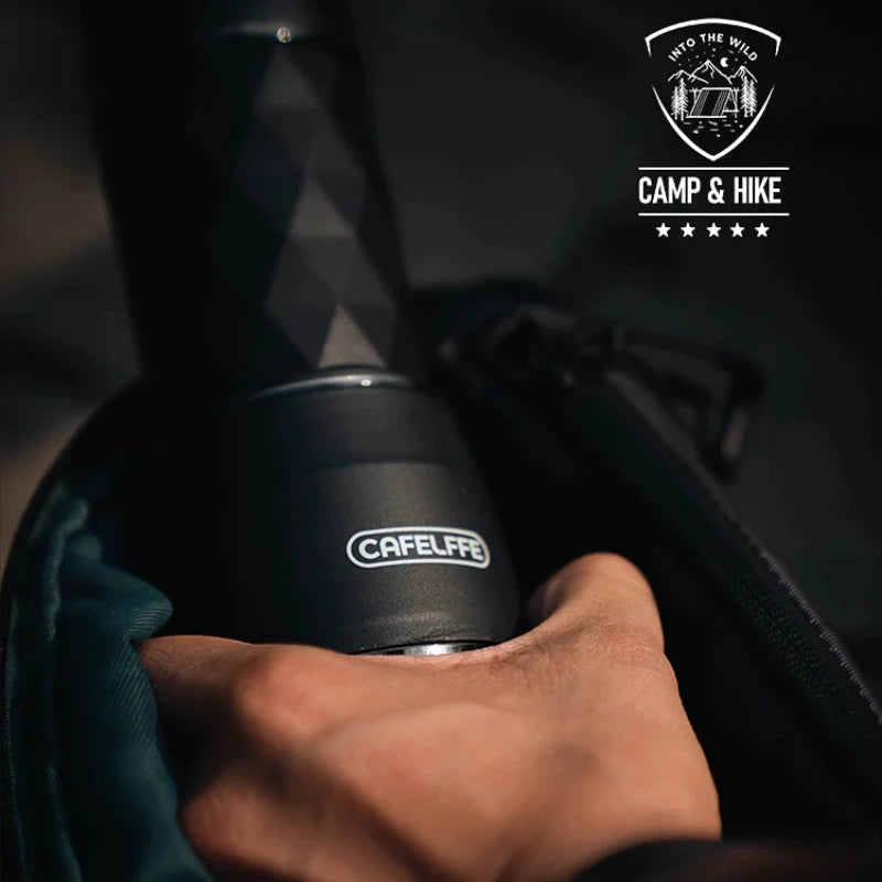 Portable Cafelffe 3-in-1 espresso maker held in a hand, featuring a sleek black design with a textured grip.