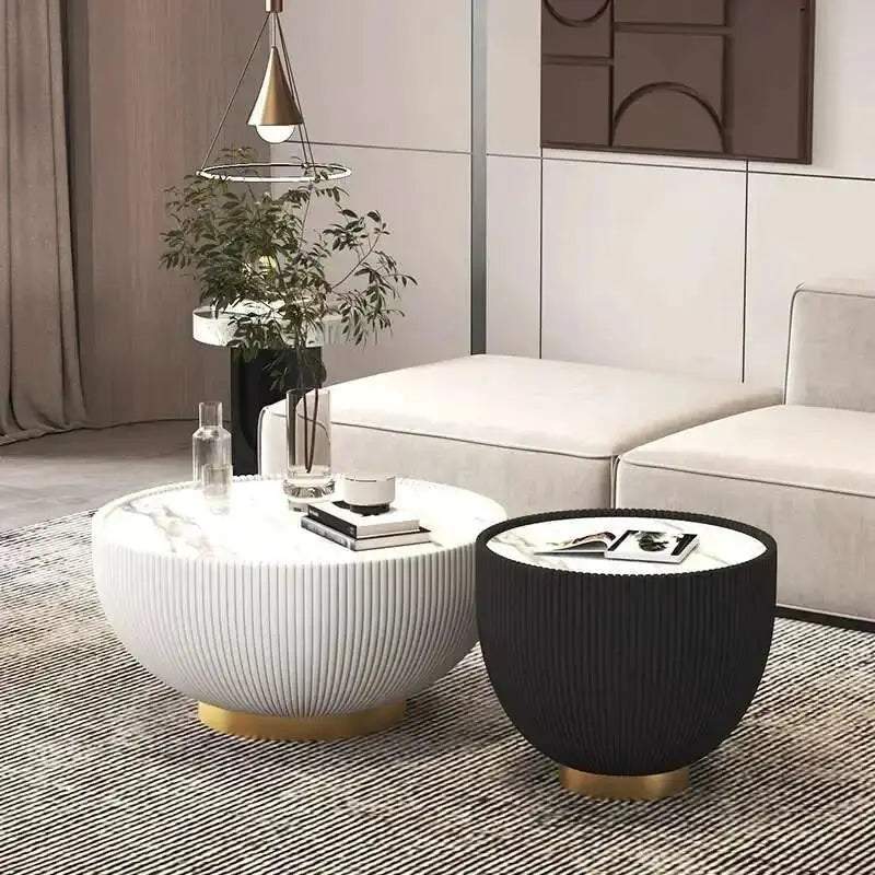 Modern living room with a white sofa, round coffee table, and black side table.
