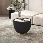 Modern black side table with gold base in a living room setting