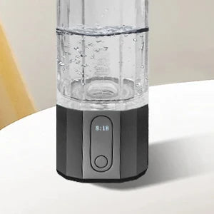 Clear water bottle with digital display on a white surface