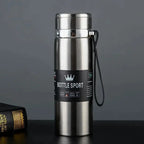 Silver stainless steel thermal water bottle with a leak-proof lid and carrying strap. Keeps drinks hot for 12 hours and cold for 24 hours, ideal for travel.