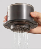 Hand holding the TIMEMORE SimpleDrip Water Dropper with water flowing evenly through its 13 precision holes.