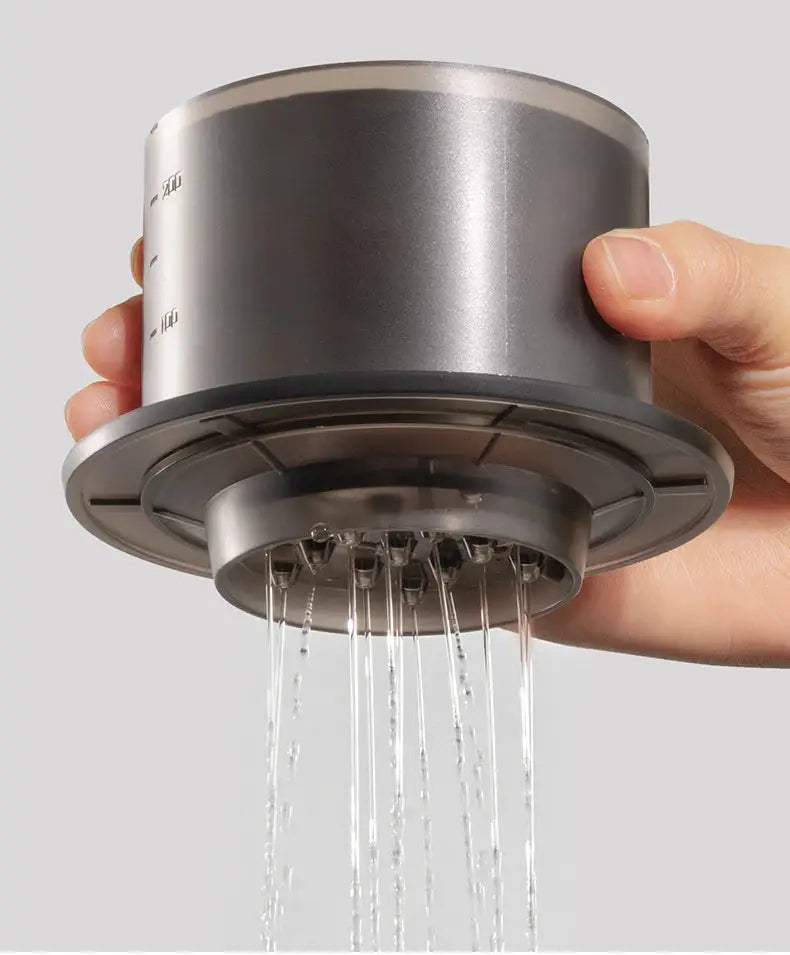 Hand holding the TIMEMORE SimpleDrip Water Dropper with water flowing evenly through its 13 precision holes.