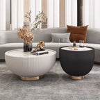 Two modern side tables in a living room setting with decor items.