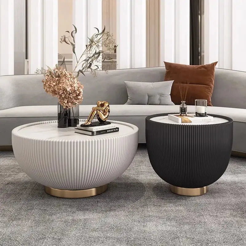 Two modern side tables in a living room setting with decor items.