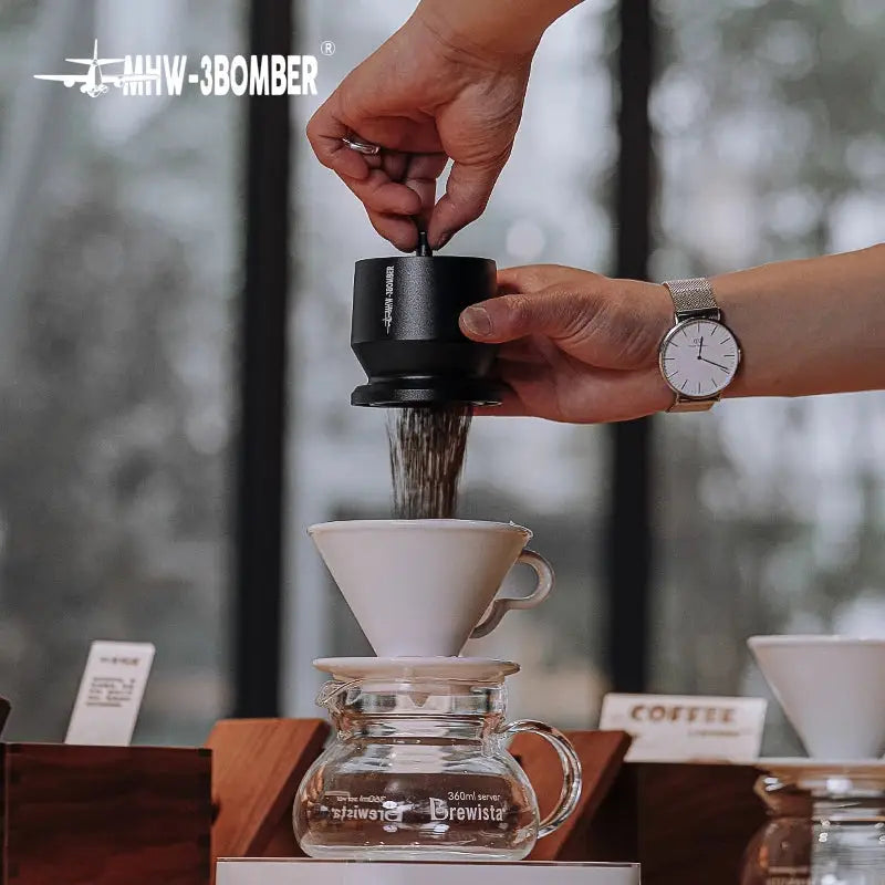 MHW-3BOMBER Coffee Dosing Funnel Aluminum Alloy Dosing Shaker dispensing grounds into a dripper, compatible with 51-54mm portafilters. Ideal espresso accessory for home baristas.