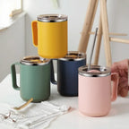 Four colorful insulated mugs with straws on a light surface.