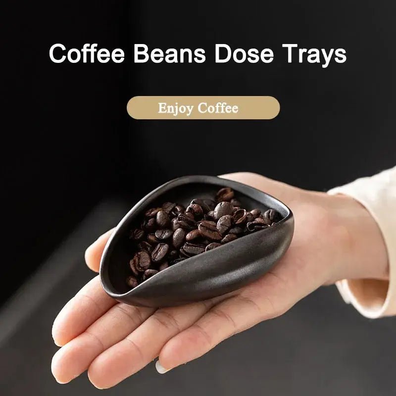 Ceramic coffee beans dosing cup with a sleek black finish, designed for precise espresso bean measuring. Features a tapered spout for easy pouring.