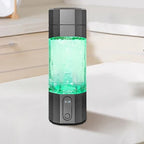 Black and gray portable water filter on a white surface