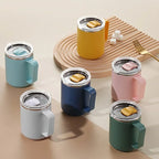 Set of colorful insulated mugs on a neutral background
