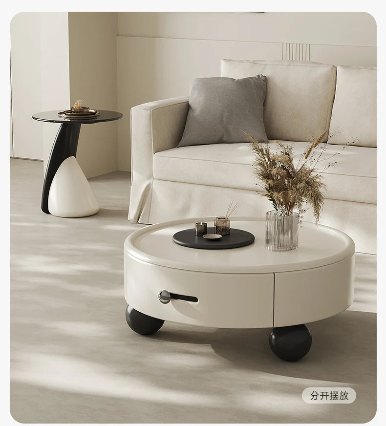 Round coffee table with storage compartments in a living room setting