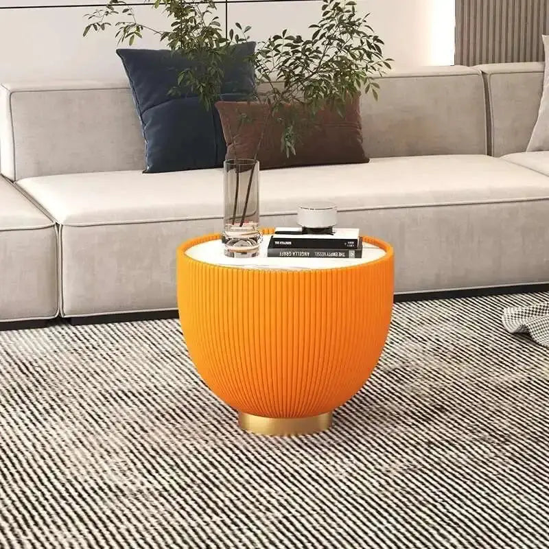 Orange side table with decorative items in a living room setting