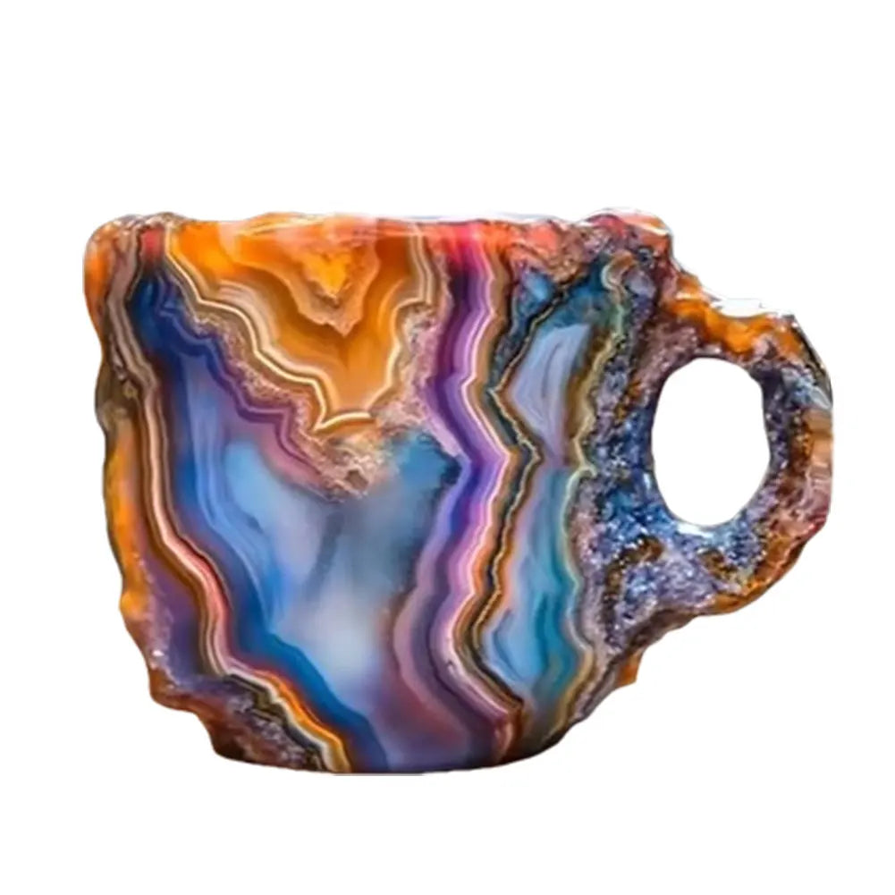 Colorful mineral crystal coffee mug with swirling patterns in orange, blue, and purple. Made of resin with an ergonomic handle.