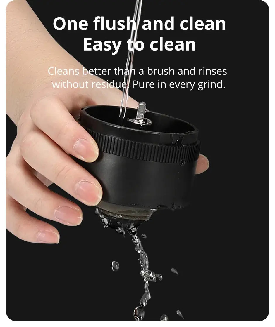 Easy-to-clean coffee grinder core being rinsed under water, ensuring no residue remains for a pure coffee grinding experience.