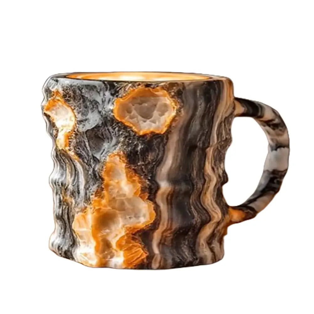 Colorful mineral crystal coffee mug with a unique swirling resin design in black, orange, and white, featuring a sturdy handle.
