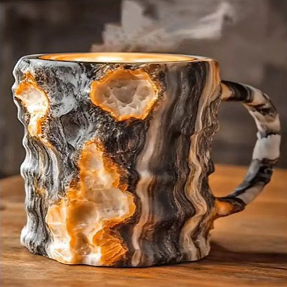 Colorful resin coffee mug with an elegant mineral crystal design, featuring patterns of orange and black.