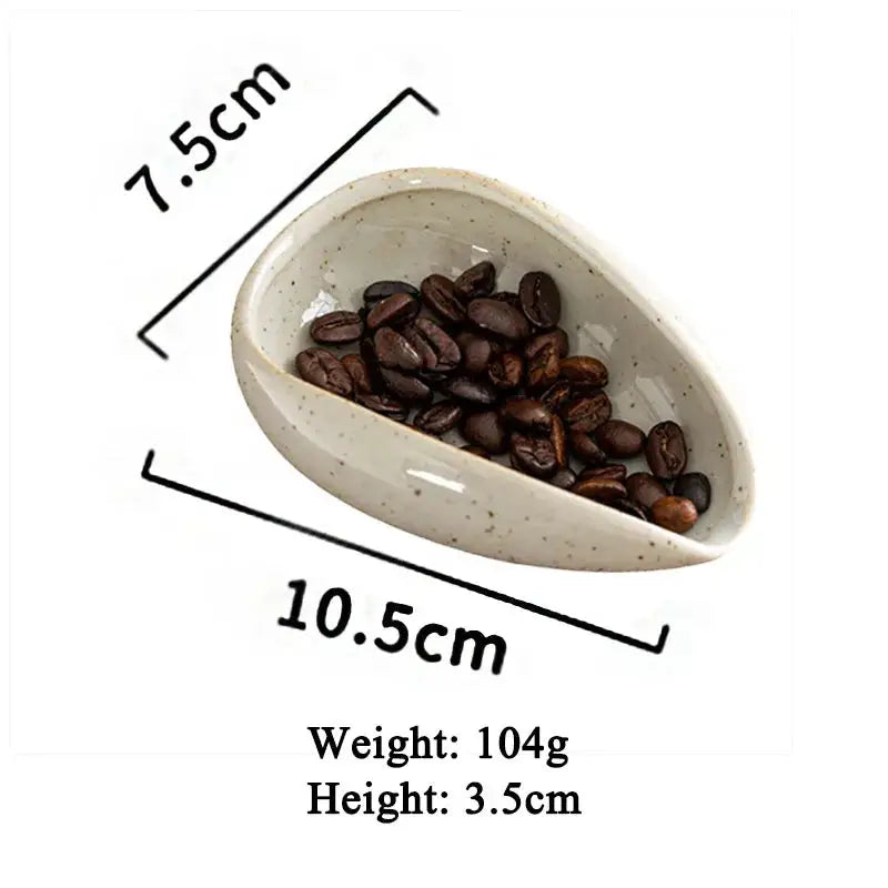 Black ceramic coffee beans dosing cup with a unique curved design and tapered spout for precise pouring. Ideal for espresso and coffee bean measuring.